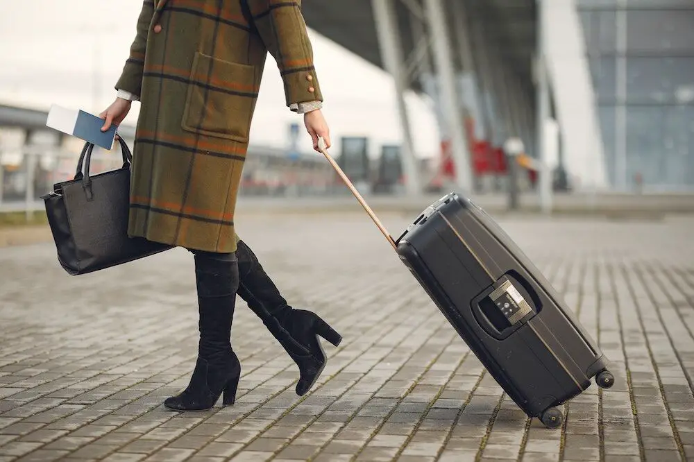 A woman traveling with her suitcase
