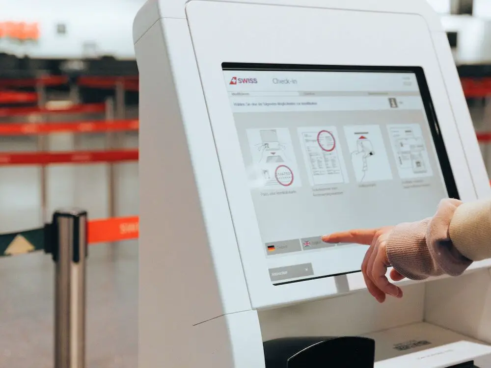 Person checking using a check in kiosk at an airport